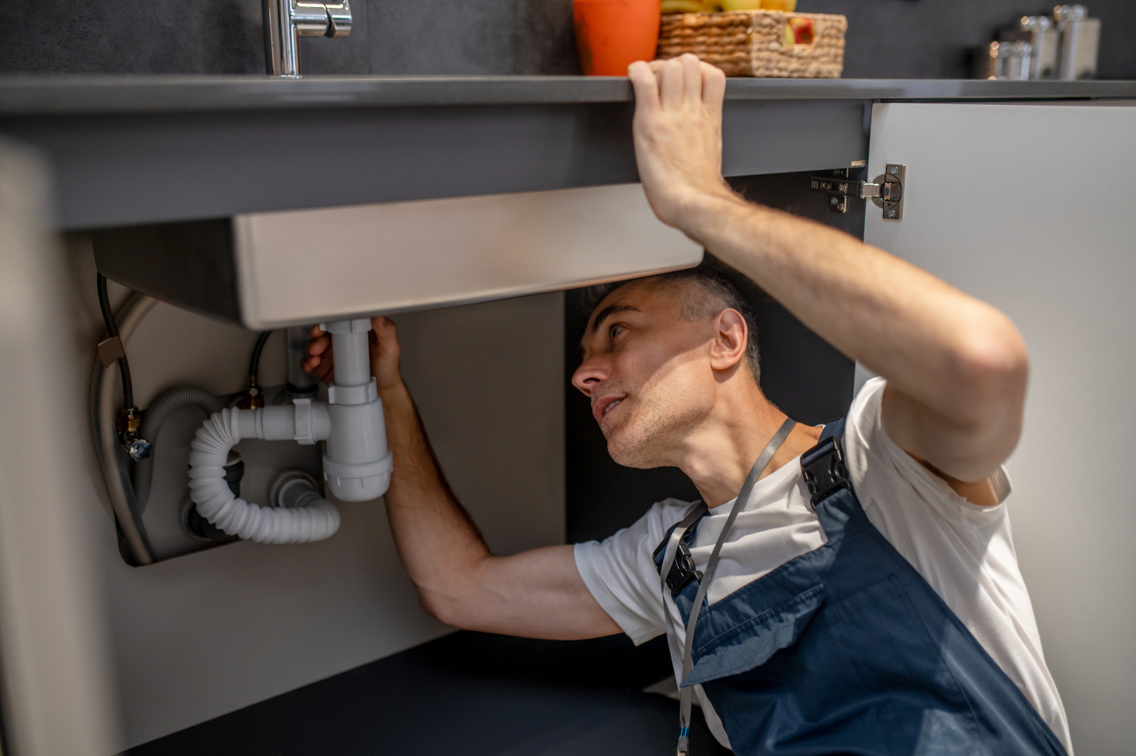 plumber-repair-experienced-attentive-middleaged-man-examining-bottom-kitchen-sink.jpg